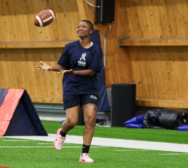 Ashayla Perry of the U.S. Navy catches a football during...