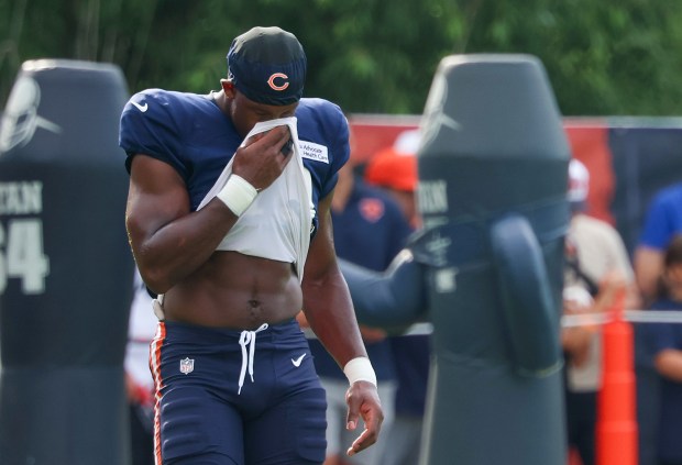 Chicago Bears tight end Jordan Murray (48) wipes off his face with his shirt during a very humid and hot training camp on July 29, 2025, in Lake Forest.  (Stacey Wescott/Chicago Tribune)