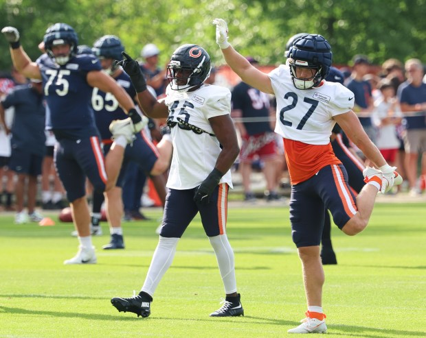 Chicago Bears offensive tackle Ozzy Trapilo (75) Chicago Bears linebacker Amen Ogbongbemiga (45) and Chicago Bears linebacker Swayze Bozeman (27) stretch out during training camp at Halas Hall on July 29, 2025, in Lake Forest.  (Stacey Wescott/Chicago Tribune)