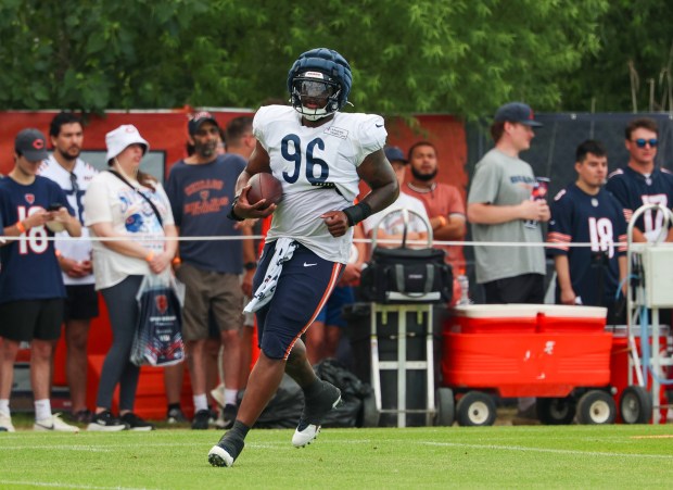Chicago Bears defensive tackle Zacch Pickens (96) runs with the ball during training camp at Halas Hall on July 29, 2025, in Lake Forest.  (Stacey Wescott/Chicago Tribune)
