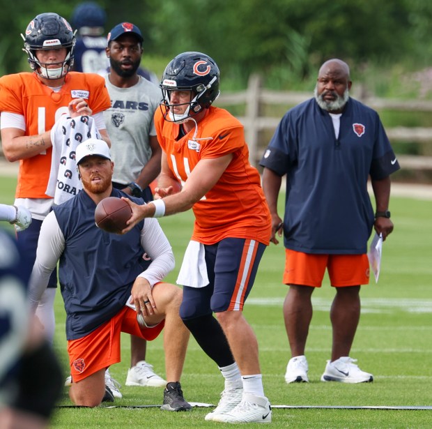 Chicago Bears quarterback Case Keenum (11) gets ready to hand off the ball to wide receiver Luther Burden III (87) during training camp at Halas Hall on July 29, 2025, in Lake Forest.  (Stacey Wescott/Chicago Tribune)