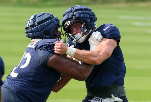 Chicago Bears offensive tackle Kiran Amegadjie (72) faces off with tight end Colston Loveland (84) during training camp at Halas Hall on July 29, 2025, in Lake Forest. (Stacey Wescott/Chicago Tribune)