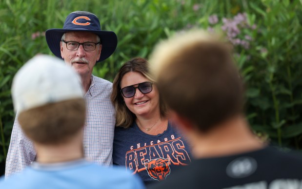 Amber Mazur poses for a photo with Chicago Bears owner George McCaskey at Chicago Bears training camp at Halas Hall on July 29, 2025, in Lake Forest. McCaskey greeted, posed for photos, and signed autographs for Bears fans as they arrived. (Stacey Wescott/Chicago Tribune)