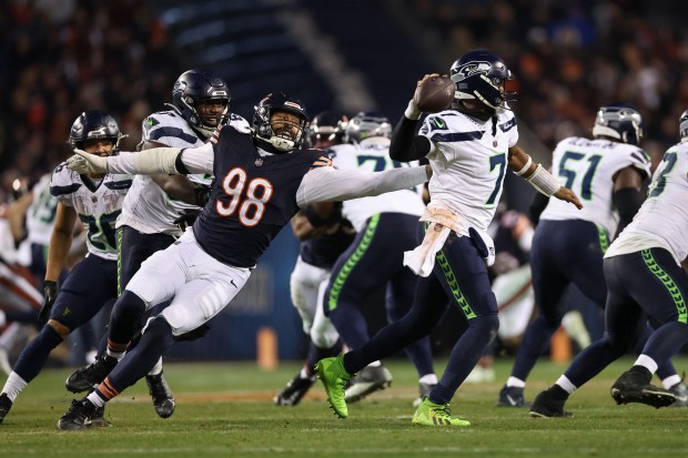 Seattle Seahawks quarterback Geno Smith (7) makes a pass while under pressure from Chicago Bears defensive end Montez Sweat (98) during the fourth quarter at Soldier Field Thursday Dec. 26, 2024, in Chicago. (Armando L. Sanchez/Chicago Tribune)