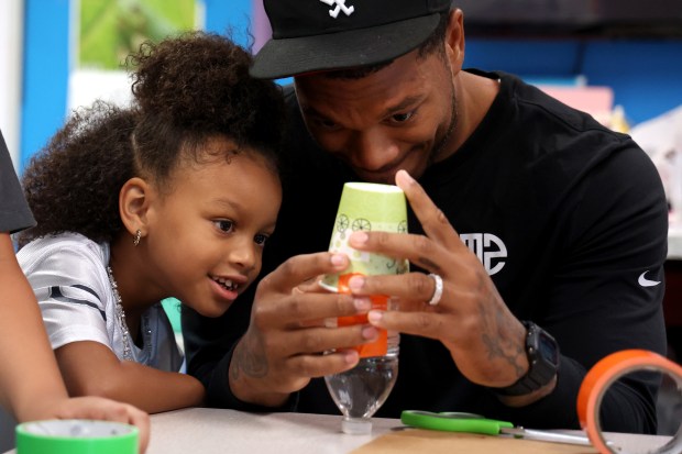 Bears receiver DJ Moore and daughter Arielle, 5, build a water-propelled rocket with others at the Chicago Boys and Girls Clubs of Chicago's Bartlett J. McCartin Club on Friday, July 18, 2025. The Boys and Girls Clubs of Chicago teamed up with Moore's Moore2Life Foundation to host a Back to School bash in celebration of local youth. (Antonio Perez/Chicago Tribune)
