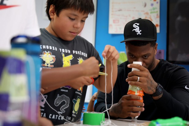 Bears DJ Moore, right, and Diego, 11, build a water-propelled rocket at the Chicago Boys and Girls Clubs of Chicago's Bartlett J. McCartin Club on Friday, July 18, 2025. The Boys and Girls Clubs of Chicago teamed up with Moore's Moore2Life Foundation to host a Back to School bash in celebration of local youth. (Antonio Perez/Chicago Tribune)