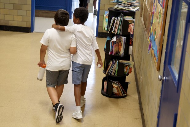 Friends walk side by side at the Bartlett J. McCartin Boys & Girls Club on Friday, July 18, 2025. The Boys and Girls Clubs of Chicago teamed up with Bears receiver DJ Moore's Moore2Life Foundation to host a Back to School bash in celebration of local youth. (Antonio Perez/Chicago Tribune)