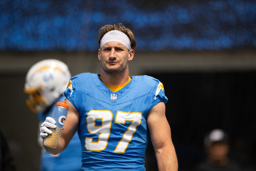 Joey Bosa (97) drinks water before an NFL football game against the Las Vegas Raiders, Sept. 8, 2024, in Inglewood, Calif. 