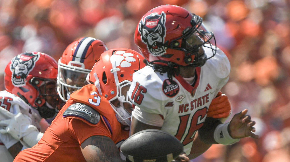 Clemson Tigersdefensive end T.J. Parker (3) hits North Carolina State Wolfpack quarterback CJ Bailey (16) to force a fumble during the first quarter at Memorial Stadium.