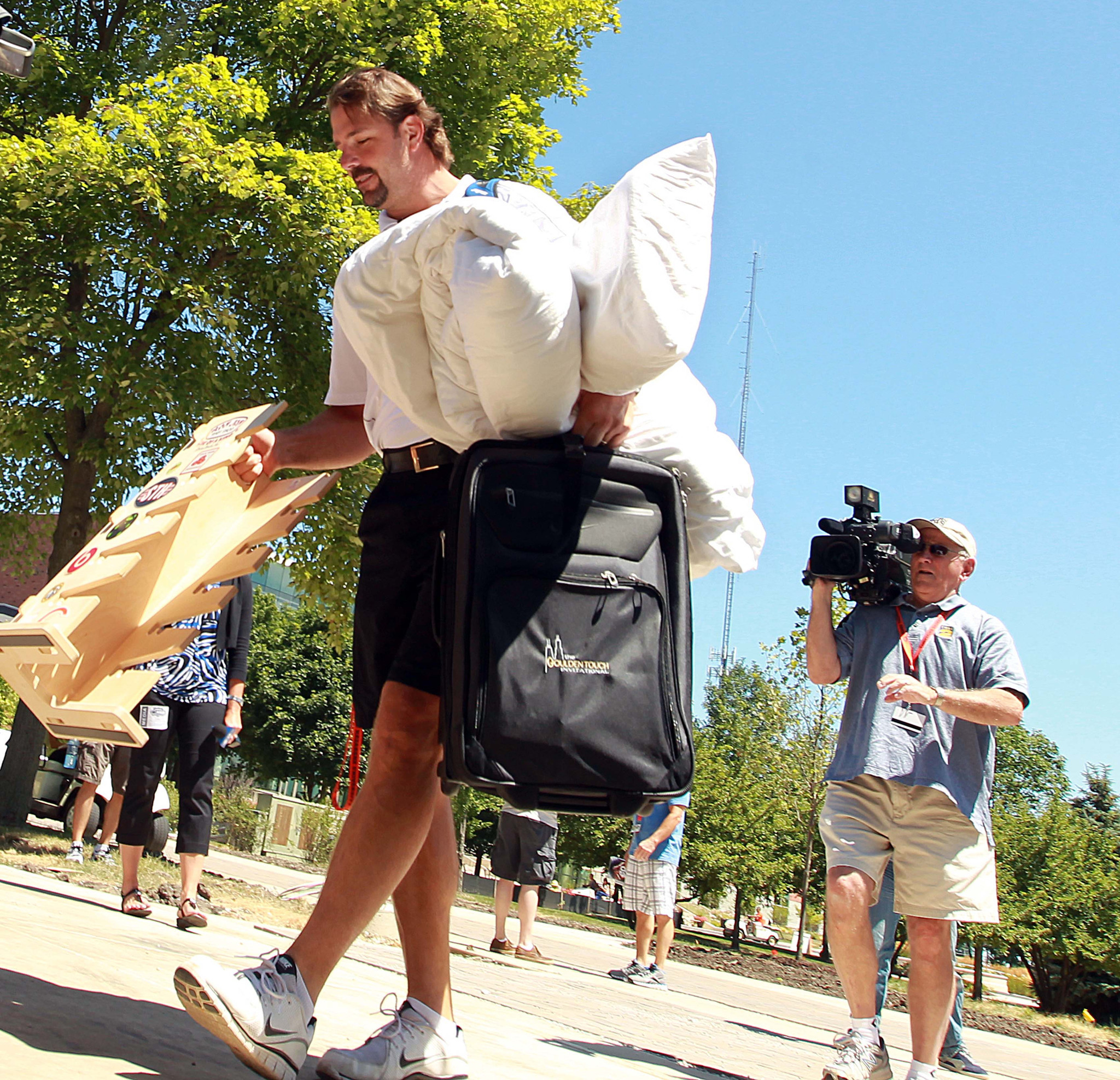 Long snap center Patrick Mannelly has his hands full with personal belongings in 2013.