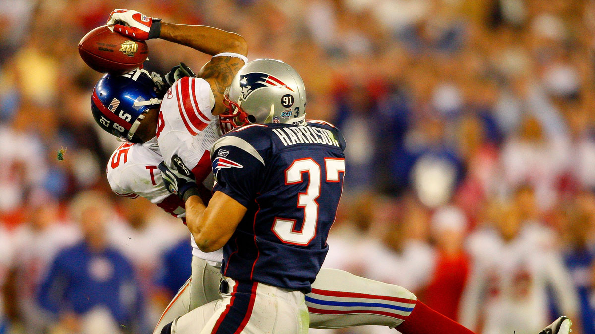 New York Giants receiver David Tyree catches a pass while in the clutches of New England Patriots safety Rodney Harrison during the fourth quarter of the Super Bowl XLII football game in Glendale, Ariz. on Feb. 3, 2008.