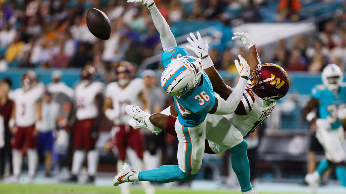 Miami Dolphins cornerback Storm Duck (36) breaks a pass intended to Washington Commanders wide receiver Mitchell Tinsley (18) during the third quarter of a preseason game at Hard Rock Stadium. 