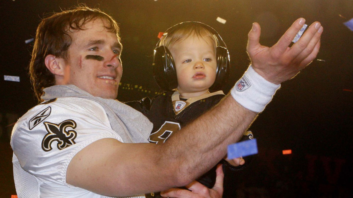 New Orleans Saints quarterback Drew Brees (9) holds up his son Baylen Brees after Super Bowl XLIV against the Indianapolis Colts at Sun Life Stadium.