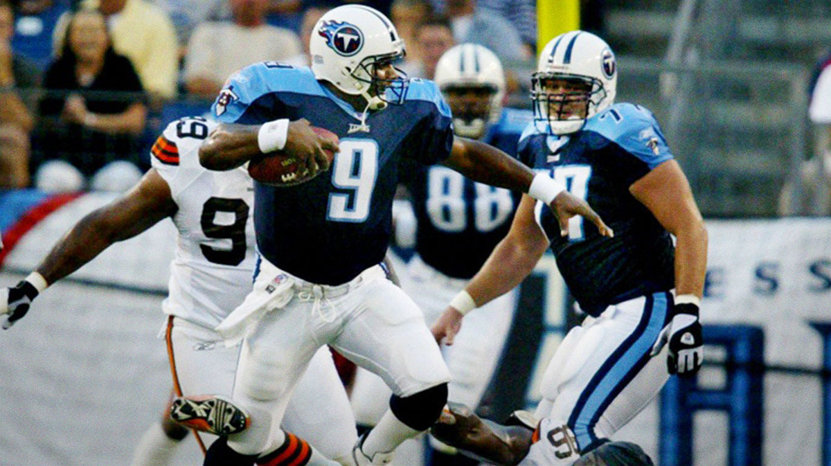 Tennessee Titans quarterback Steve McNair (9) jumps over Cleveland Browns defensive lineman Kenard Lang (96) during their preseason game at The Coliseum in Nashville on Aug. 9, 2003. The Titans came out on top 10-6.