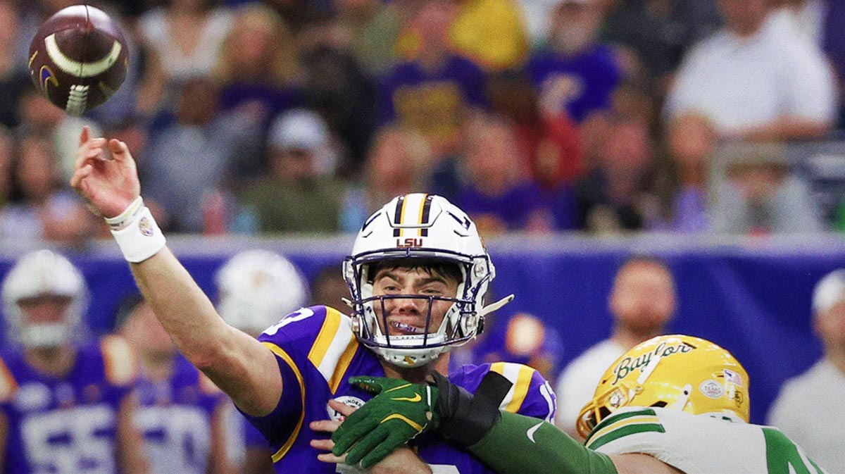 LSU Tigers quarterback Garrett Nussmeier (13) is hit by Baylor Bears linebacker Josh White (44) in the second half at NRG Stadium.