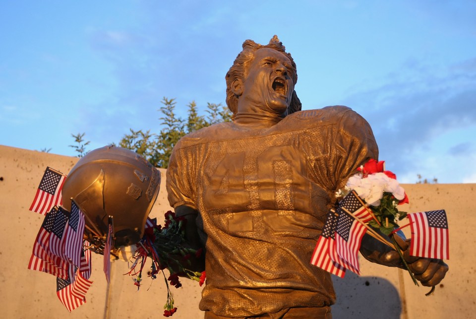 GLENDALE, AZ - SEPTEMBER 11: Fans adorn the Pat Tillman statue with American flags in honor of the 10 year anniversary of the 9/11 attacks following the NFL season opening game between the Carolina Panthers and the Arizona Cardinals at the University of Phoenix Stadium on September 11, 2011 in Glendale, Arizona. (Photo by Christian Petersen/Getty Images)