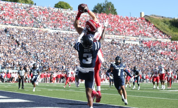 Caleb Lohner of the Utah Utes catches a touchdown pass over JD Drew (3) of the Utah State Aggies during the first half of their game at Maverik Stadium on September 14, 2024 in Logan, Utah. (Photo by Chris Gardner/Getty Images)