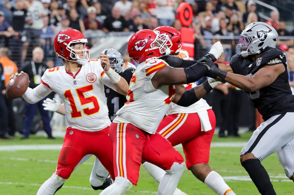 LAS VEGAS, NEVADA - OCTOBER 27: Patrick Mahomes #15 of the Kansas City Chiefs throws a pass as Trey Smith #65 of the Chiefs blocks Tyree Wilson #9 of the Las Vegas Raiders in the third quarter of their game at Allegiant Stadium on October 27, 2024 in Las Vegas, Nevada. The Chiefs defeated the Raiders 27-20. (Photo by Ethan Miller/Getty Images)