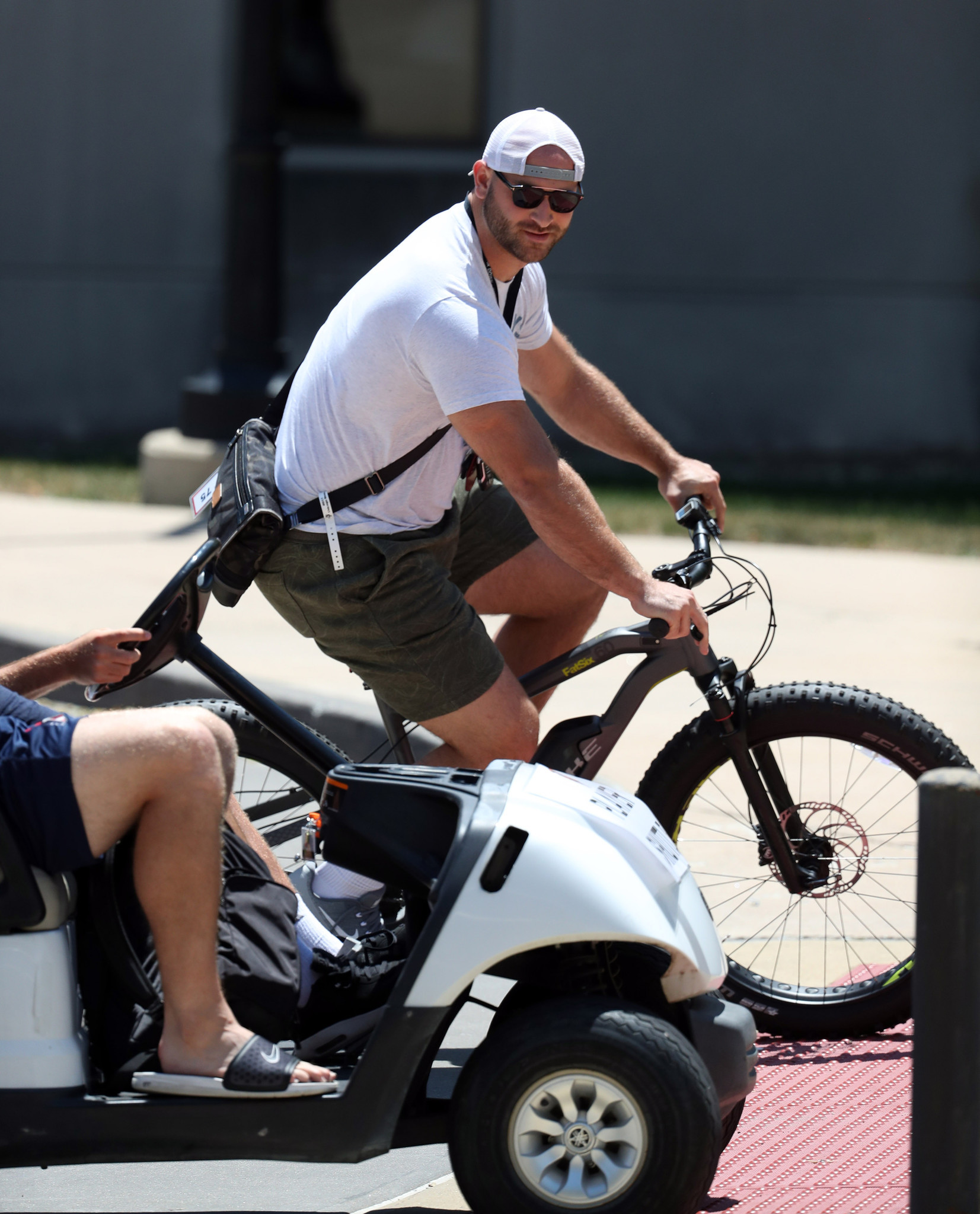 Kyle Long rides a bike as the Bears report to training camp on July 19, 2018.