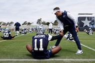 Dallas Cowboys defensive end Micah Parsons (11) is greeted by head coach Brian...