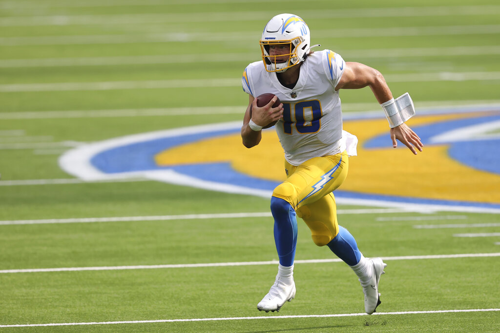 Los Angeles Chargers quarterback Justin Herbert (10) runs with the ball during an NFL football game against the Carolina Panthers, Sunday, Sept. 27, 2020, in Inglewood, Calif. (AP Photo/Peter Joneleit)