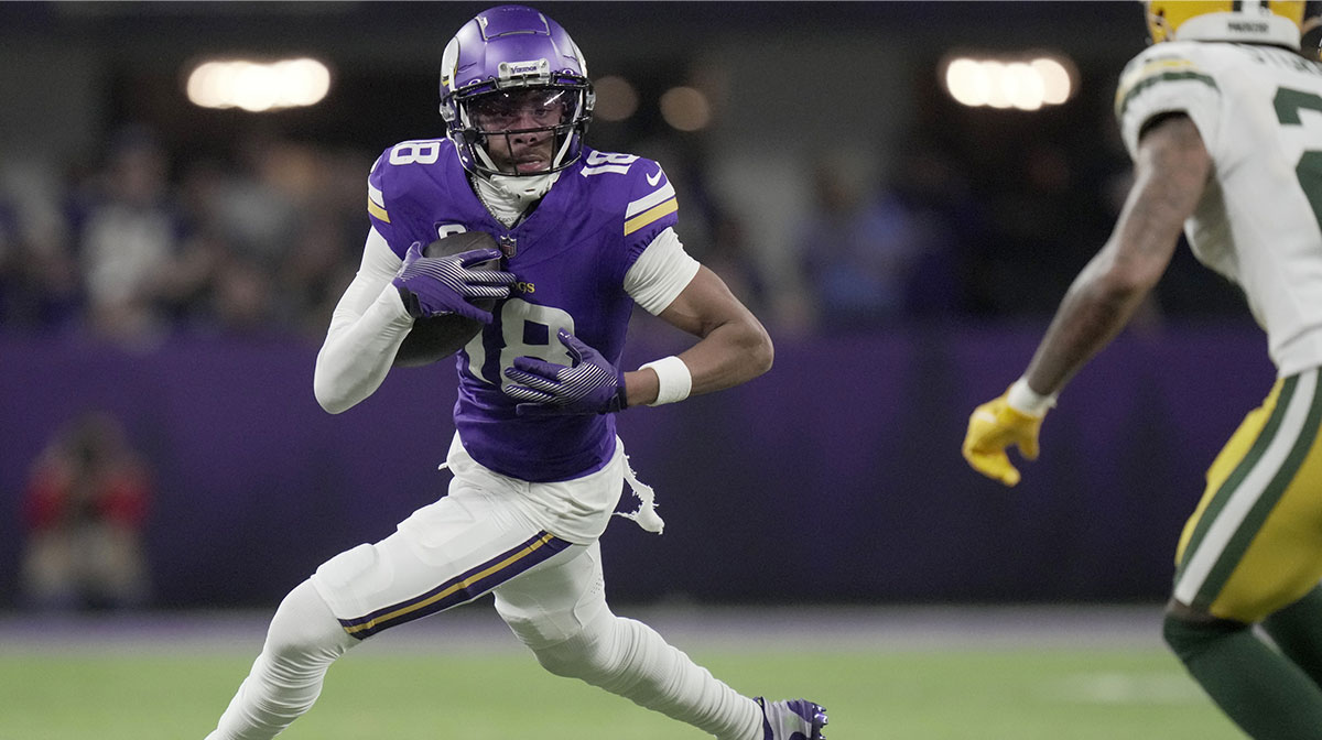 Minnesota Vikings wide receiver Justin Jefferson (18) looks for running room after a reception against the Green Bay Packers at U.S. Bank Stadium.