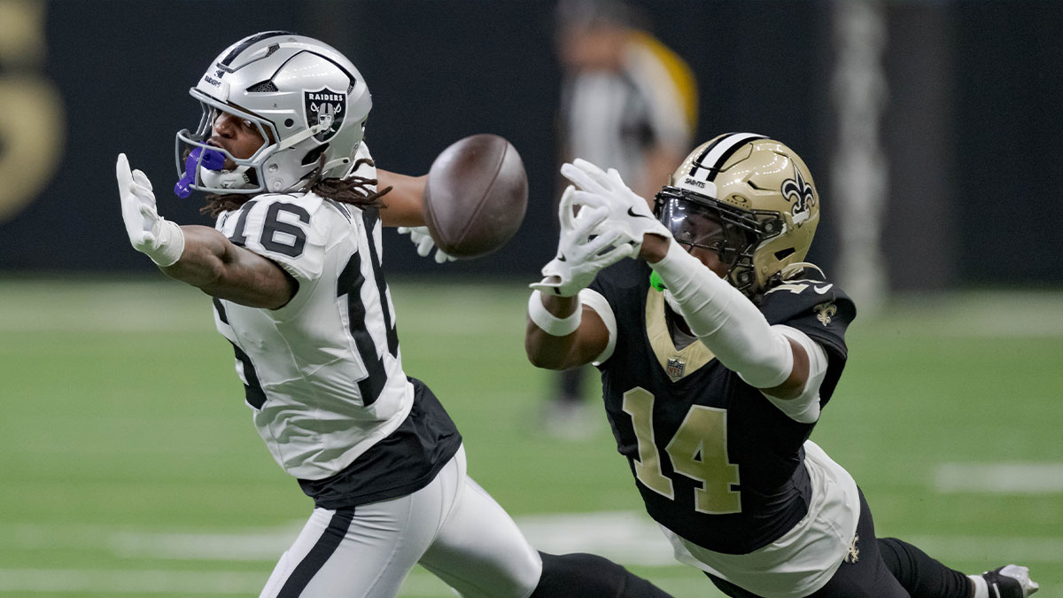 Las Vegas Raiders wide receiver Jakobi Meyers (16) misses a catch as New Orleans Saints cornerback Kool-Aid McKinstry (14) also attempts to grab it during the third quarter at Caesars Superdome.
