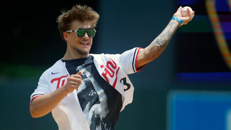 Minnesota Gophers football star Koi Perich throwing out the first pitch at a Minnesota Twins game