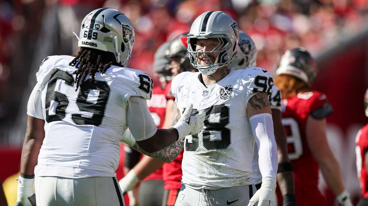 Las Vegas Raiders defensive end Maxx Crosby (98) and defensive tackle Adam Butler (69) reacts after a play against the Tampa Bay Buccaneers in the second quarter at Raymond James Stadium.