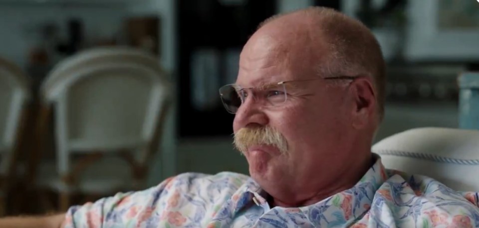 Close-up of a man wearing glasses and a patterned shirt.
