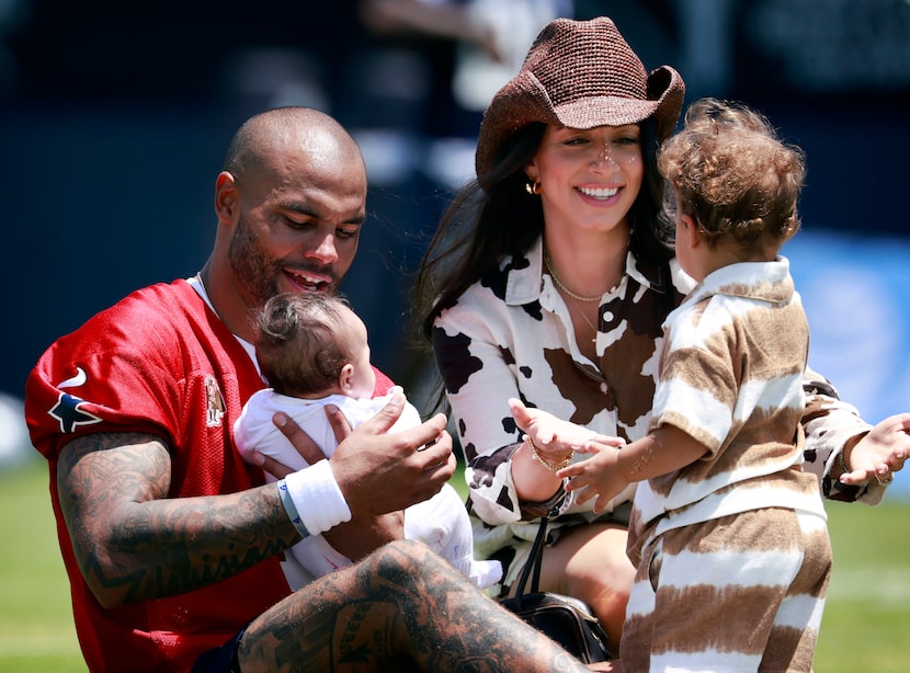 Dallas Cowboys quarterback Dak Prescott (4) takes his newborn daughter Aurora Rayne from his...