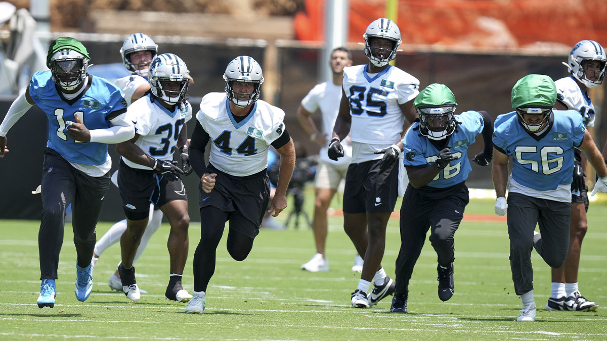 Carolina Panthers linebacker Nic Scourton (11), cornerback Mike Reid (35), long snapper JJ Jansen (44), tight end James Mitchell (85), safety Demani Richardson (36) and linebacker Christian Rozeboom (56) hustle to the ball during minicamp at Bank of America Stadium.