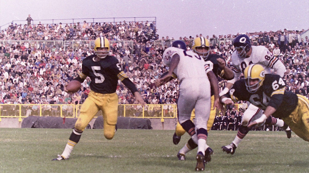 Green Bay Packers running back Paul Hornung (5) runs the sweep as guard Jerry Kramer (64) attempts to block Chicago Bears defensive back Dave Whitsell (23). The Packers defeated the Bears 49-0 on Sept. 30, 1962 at New City Stadium, later renamed Lambeau Field, in Green Bay, Wis. Gpg Historical Packers Vs Bears 08182022 0006