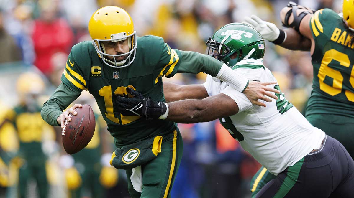 Green Bay Packers quarterback Aaron Rodgers (12) avoids pressure from New York Jets nose tackle Quinnen Williams (95) during the second quarter at Lambeau Field. 