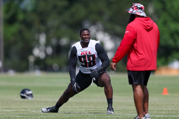 Atlanta Falcons defensive tackles Ruke Orhorhoro (98) talks with an assistant coach during the Atlanta Falcons Rookie Minicamp at the Atlanta Falcons Training Camp, Friday, May 10, 2024, in Flowery Branch, Ga. (Jason Getz / AJC)