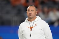 Texas head coach Steve Sarkisian watches players warm up before the Cotton Bowl College...
