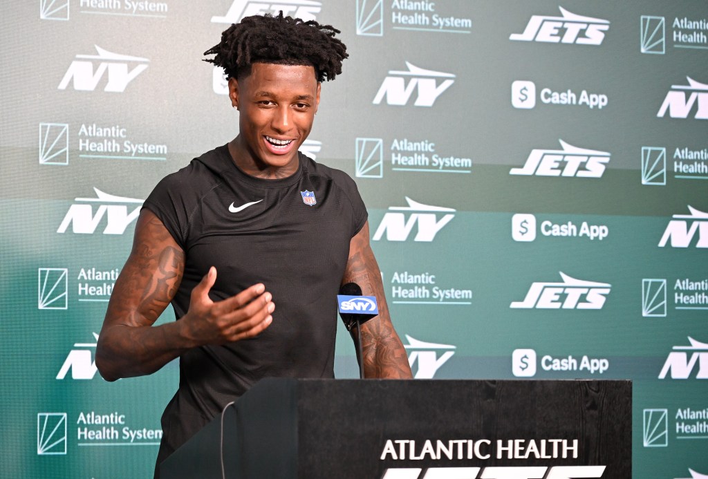 A smiling Sauce Gardner, who recently signed a big extension with the Jets, talks with reporters on July 22, 2025.