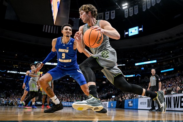 Caleb Lohner (33) of the Baylor Bears drives on Miles Norris (5) of the UC Santa Barbara Gauchos during the second half of Baylor's 74-56 win in the first round of the NCAA men's basketball tournament at Ball Arena in Denver on Friday, March 17, 2023. (Photo by AAron Ontiveroz/The Denver Post)