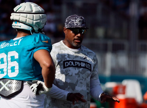 Miami Dolphins defensive tackle Alex Huntley (96) talks with defensive...