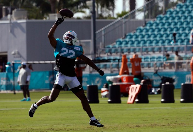 Miami Dolphins safety Elijah Campbell (22) goes up for a...