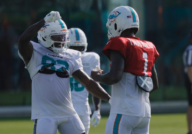 Miami Dolphins wide receiver Dee Eskridge (82) and quarterback Tua...