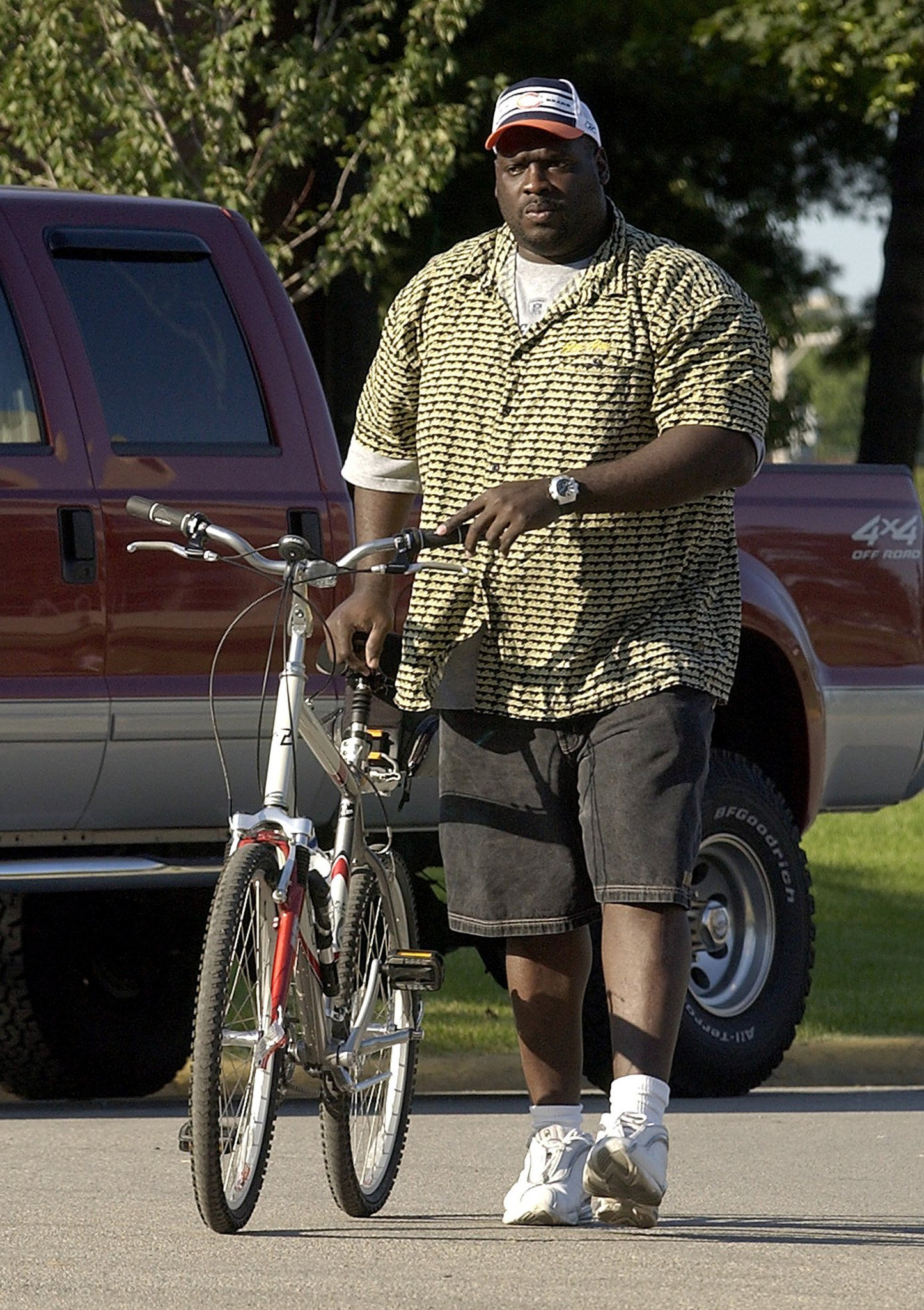 Ted Washington walks his bicycle to the dorm in 2003.