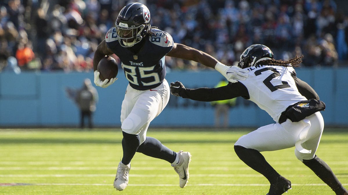 Tennessee Titans tight end Chigoziem Okonkwo (85) stiff arms Jacksonville Jaguars safety Rayshawn Jenkins (2) during the first half at Nissan Stadium.