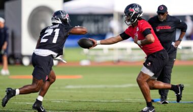 Houston Texans quarterback C.J. Stroud, right, hands off to runningback Nick Chubb (21) during the team's NFL football training camp Wednesday, July 23, 2025, in Houston. (AP Photo/Ashley Landis)