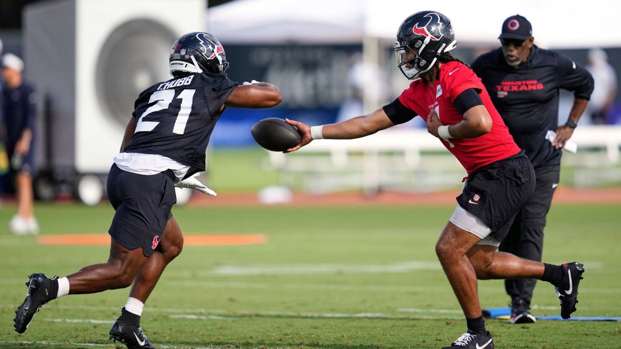 Houston Texans quarterback C.J. Stroud, right, hands off to runningback Nick Chubb (21) during the team's NFL football training camp Wednesday, July 23, 2025, in Houston. (AP Photo/Ashley Landis)