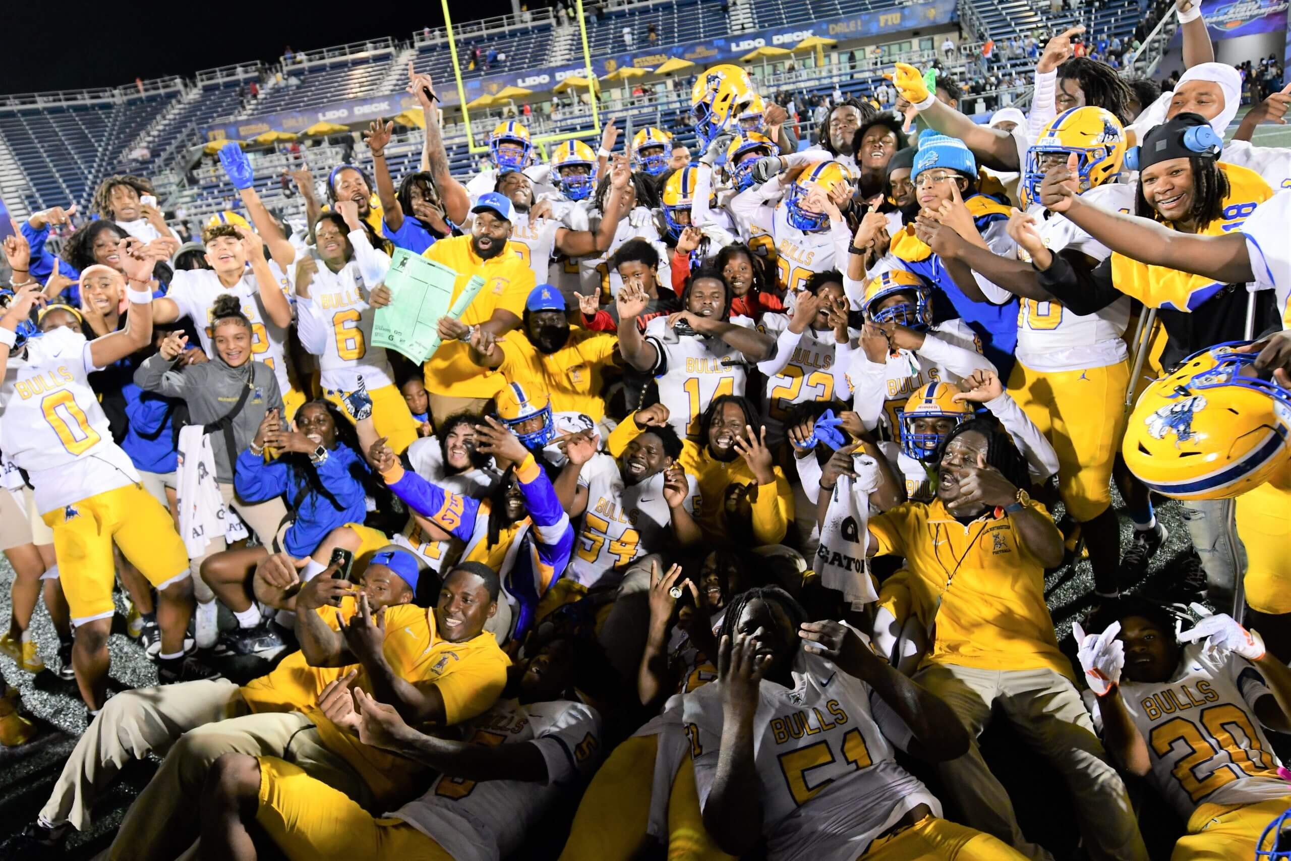 Miami Northwestern's team poses for a photo following their victory over Raines in the Class 3A state championship at Florida International University on Dec. 14, 2024.
