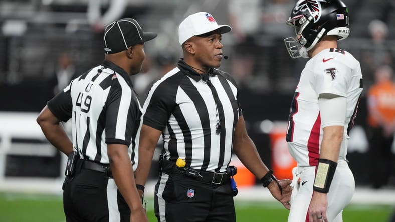 Kirk Cousins talking with officials during a Falcons game against the Las Vegas Raiders at Allegiant Stadium. Kirk Cousins Packers.