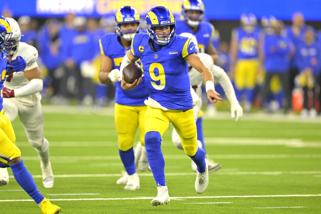 Los Angeles Rams quarterback Matthew Stafford (9) carries the ball to the 5-yard line against the Arizona Cardinals at SoFi Stadium.