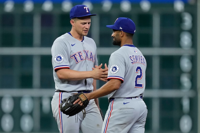Texas Rangers shortstop Corey Seager (5) and second baseman Marcus Semien (2) celebrate...