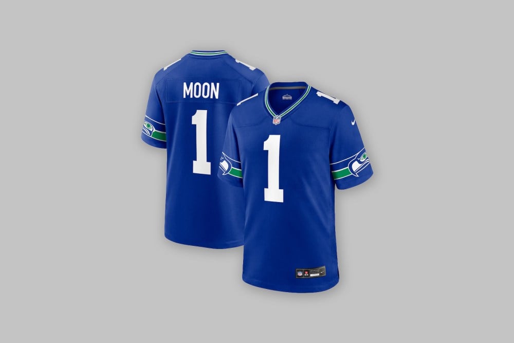 Front and back views of the Warren Moon Seattle Seahawks Nike Alternate Game Jersey in bright blue against a light gray background.